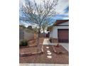 Landscaped front yard with walkway and rock features adding character to the home's curb appeal at 6717 Sheffield Dr, Las Vegas, NV 89108