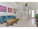 Open concept living room with staircase and contemporary furnishings at 6938 Silk Oak Ct, Las Vegas, NV 89148