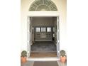 Welcoming entryway with an open door, decorative rug, and views of the home's interior at 7444 Grassy Field Ct, Las Vegas, NV 89131