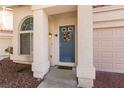 Welcoming front door with decorative wreath and charming architecture enhances the curb appeal at 8872 Hampton Green Ave, Las Vegas, NV 89129