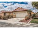 Attractive single-story home featuring a well-manicured front yard and two-car garage at 9071 Ravenhurst St, Las Vegas, NV 89123