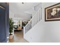 Inviting entryway featuring staircase, tile floors, and views of the living spaces at 9792 Valmeyer Ave, Las Vegas, NV 89148