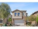 Charming two-story home featuring a stone-accented facade and an attached two-car garage at 10052 Silver Comet Ct, Las Vegas, NV 89178