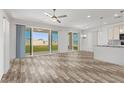 Bright, open living space with wood-style flooring and sliding glass doors to the backyard at 10052 Silver Comet Ct, Las Vegas, NV 89178