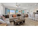 Open-concept living space featuring hardwood floors, lots of seating and tons of natural light at 10052 Silver Comet Ct, Las Vegas, NV 89178