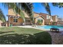 Inviting backyard featuring a sparkling pool, patio with pergola and lush greenery at 1033 Via Dell Bacio Dr, Henderson, NV 89052