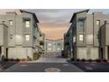 Modern townhome exteriors showcasing clean lines, neutral colors, and private garages in a community setting at 11256 Rainbow Peak Ave # 207, Las Vegas, NV 89135