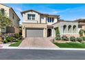 Beautiful home featuring a paver driveway, two-car garage, and charming landscaping at 12054 Portamento Ct, Las Vegas, NV 89138