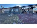 Exterior view of the home featuring a unique overhang and a driveway at 1275 Westwind Rd, Las Vegas, NV 89146