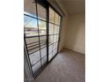 Private outdoor patio space with sliding glass door access from carpeted room at 2080 Karen Ave # 15, Las Vegas, NV 89169