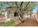 Backyard featuring low maintenance landscaping with mature shade trees and partial fencing at 2201 Tiger Links Dr, Henderson, NV 89012