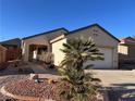 Charming single-story home featuring desert landscaping, a two-car garage, and a covered front porch at 2201 Tiger Links Dr, Henderson, NV 89012