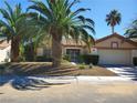 Beautiful single-story home boasts desert landscaping, mature palm trees, and inviting curb appeal at 2700 Crown Ridge Dr, Las Vegas, NV 89134