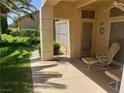 Enjoy outdoor living on this covered patio with comfortable seating overlooking the landscaped yard at 2700 Crown Ridge Dr, Las Vegas, NV 89134