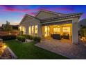 Outdoor living space with covered patio, fire pit, seating area, and manicured lawn at 3018 Fall Solstice Ct, Las Vegas, NV 89138