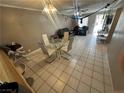 Open concept living room and dining area with neutral tile flooring at 3230 Cameron St # A, Las Vegas, NV 89102