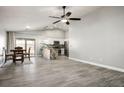 Open concept living space featuring tile flooring, a ceiling fan, and combined kitchen and dining areas at 3334 Flying Colt Ct, North Las Vegas, NV 89032