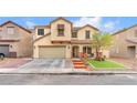 Charming two-story home featuring a well-manicured lawn, a two-car garage, and inviting curb appeal in a residential neighborhood at 4822 Jade Ridge St, North Las Vegas, NV 89081