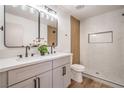 Updated bathroom featuring double sinks, modern fixtures, and a beautifully tiled shower with a built-in niche at 4954 Palmyra Ave, Las Vegas, NV 89146