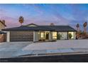 Single story home featuring a well manicured yard, a black roof, and a two car garage at 528 Sheffield Dr, Henderson, NV 89014