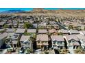 An aerial view of a residential area with desert mountains in the background at 569 Brompton St, Las Vegas, NV 89178