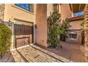 Inviting entryway with double doors, stone accents, gas fireplace, and lush greenery at 6 Fire Rock Ct, Las Vegas, NV 89141