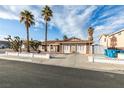 Lovely single-story home with desert landscaping, palm trees, and an expansive driveway at 6202 La Palma Pkwy, Las Vegas, NV 89118