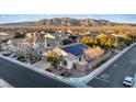 Aerial view of a home with solar panels in a neighborhood with mountain views at 6944 Puetollano Dr, North Las Vegas, NV 89084