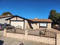 Street view of a single-story house with a white garage door and desert landscaping at 7176 Southpark Ct, Las Vegas, NV 89147