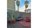 Secluded backyard with desert landscaping, patio, and block wall for privacy at 7186 Cressida Ct, Las Vegas, NV 89113