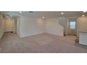 Spacious living room featuring neutral carpet, recessed lighting and white walls at 7246 Copper Grove Ave, Las Vegas, NV 89113