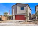 Modern two-story home boasts a red garage door, desert landscaping, and concrete driveway at 804 Ruby Sedona Ave # Lot 152, North Las Vegas, NV 89081