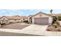 Exterior showcasing desert landscaping, an attached two-car garage, and a concrete driveway at 10029 Netherton Dr, Las Vegas, NV 89134