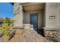 Close-up of the home's entrance with stone accents, covered porch, and a well-maintained brick walkway at 10699 Sariah Skye Ave, Las Vegas, NV 89166