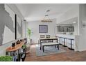 Open dining area featuring a wooden table with bench seating, modern light fixture, and abstract art, flowing seamlessly into the kitchen at 1800 Edmond St # 215, Las Vegas, NV 89146