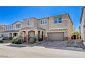 Inviting two-story home featuring a covered porch, neutral exterior paint, and attached garage at 183 Baru Belin Ave, Las Vegas, NV 89183