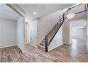 Bright open foyer features wood-look flooring, a modern chandelier and staircase at 183 Baru Belin Ave, Las Vegas, NV 89183