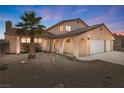 Attractive home featuring a tile roof, desert landscaping, and an attached three-car garage at 2111 River City Dr, Laughlin, NV 89029