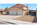 Exterior view showing the three-car garage, driveway, and gated side yard at 2111 River City Dr, Laughlin, NV 89029