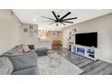 Bright and open living room with sleek wood floors and a stylish ceiling fan at 2451 N Rainbow Blvd # 2076, Las Vegas, NV 89108