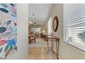 Inviting entryway featuring a decorative mirror, console table, and an open view into the living and dining areas at 2537 Nashira St, Henderson, NV 89044