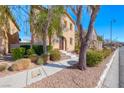 Two-story home with stucco exterior with well maintained landscaping at 3204 Romanesque Art Ave, Henderson, NV 89044