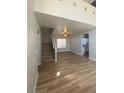 Bright living room featuring wood floors, stairs, and an abundance of natural light at 3304 Michelangelo Ct, Las Vegas, NV 89129