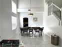 Open concept dining area with modern lighting and staircase to the second floor at 3751 Morning Canyon St, Las Vegas, NV 89147