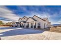 Row of modern homes with large driveways, clean landscaping, and a mountain backdrop at 376 E Erin St # 1, Pahrump, NV 89048