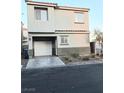 Two-story home featuring desert landscaping, an attached garage, and neutral color palette at 4006 Morning Peace St, Las Vegas, NV 89115