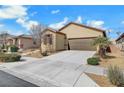 Charming single-story home with a two-car garage and desert landscaping at 4340 Hatch Bend Ave, North Las Vegas, NV 89031