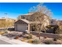 View of the front of a two-story home showcasing desert landscaping, stone accents, and a well-kept yard at 436 Trevinca St, Las Vegas, NV 89138