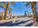 Gated community entrance with lush landscaping and palm trees provides security and curb appeal at 4555 E Sahara Ave # 132, Las Vegas, NV 89104