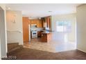 Open-concept kitchen featuring wood cabinets and modern white appliances at 4905 Morning Falls Ave, Las Vegas, NV 89131